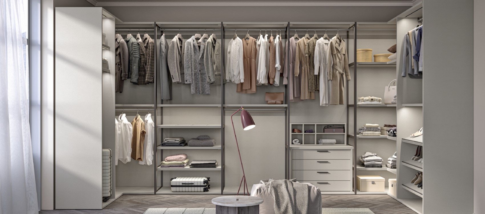 Modular walk in wardrobes by Colombini with open metal dividers between the wardrobes in Leather Grey finish.