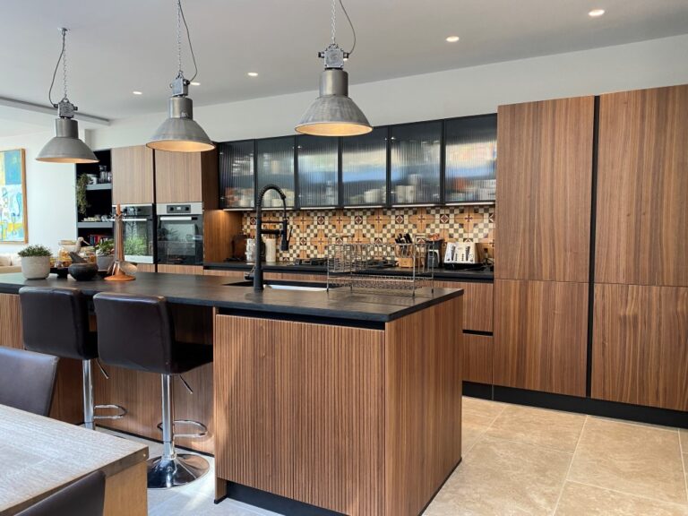 Walnut and black finish kitchen by Next 125 with tall units and statement island