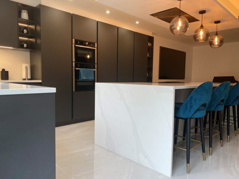 Kitchen with lava black tall units and concrete effect island units